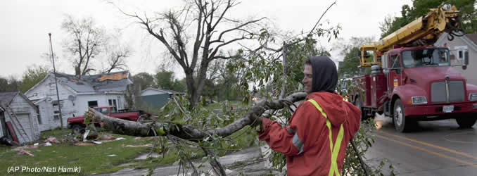 A member of a cleanup crew clears a branch in Thurman, Iowa, Sunday, April 15, 2012, after severe weather came through the area. A large part of the town in the western part of the state was destroyed Saturday night, possibly by a tornado, but no one was injured or killed. Fremont County Emergency Management Director Mike Crecelius said about 75 percent of the 250-person town was destroyed. (AP Photo/Nati Harnik)